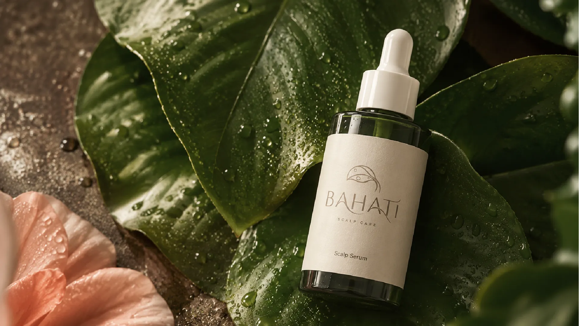 Bahati scalp serum bottle amongst leaves and stone